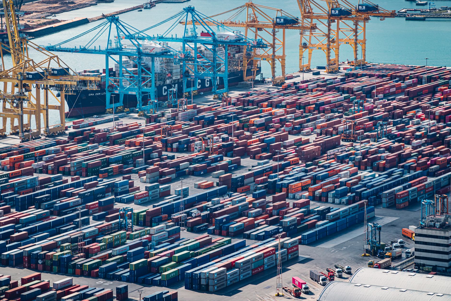 aerial photography of blue and red cargo containers on a pier