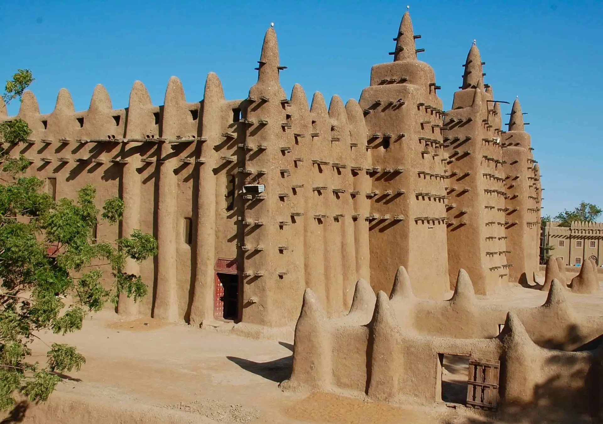 A light sand coloured building with smooth sides, almost like a giant sand castle