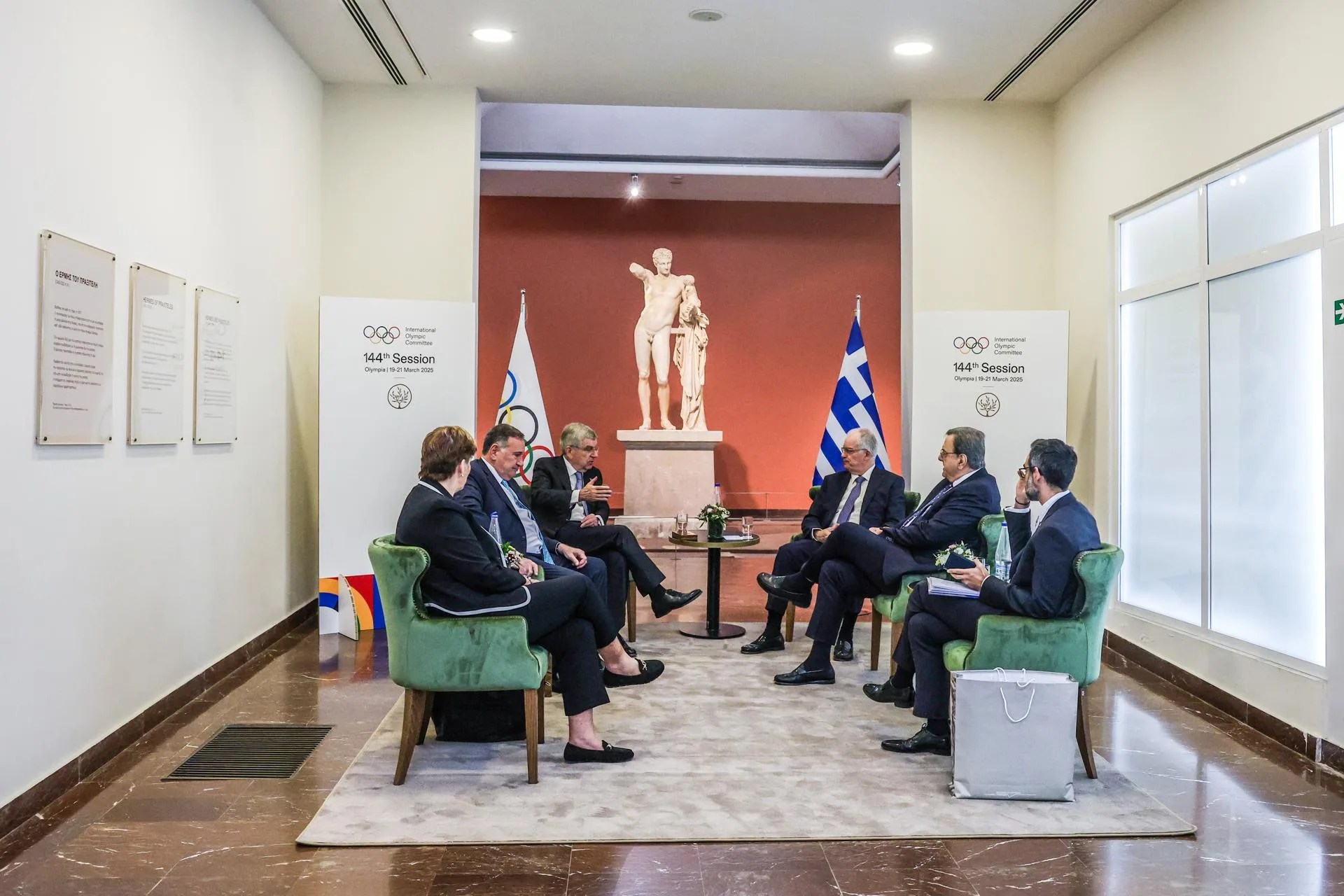 A handout photo made available by the Greek Presidential Office shows Greece's President Konstantinos Tasoulas (C-R) and the International Olympic Committee (IOC) President Thomas Bach (CL), attend a meeting before the start of the work of the 144th Session of the International Olympic Committee, at the archaeological museum in Ancient Olympia, Greece, 18 March 2025. EFE-EPA/THEODOR MANOLOPOULOS / GREEK PRESIDENTIAL OFFICE HANDOUT HANDOUT EDITORIAL USE ONLY/NO SALES
