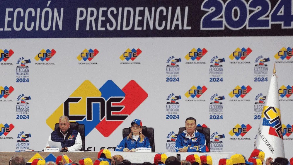 El presidente del Consejo Nacional Electoral (CNE) de Venezuela, Elvis Amoroso (i), presenta un boletín oficial, el 28 de julio de 2024, en Caracas