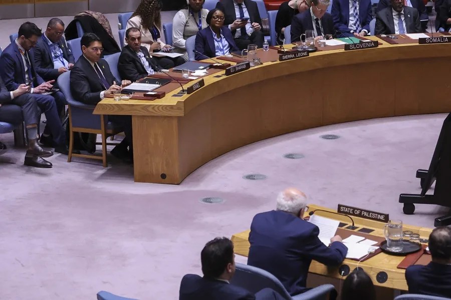 El embajador de Israel ante la ONU, Danny Danon (i) y el exrehén israelí de Hamás Eli Sharabi (i2), escuhan al representante de Palestina, Riyad Mansour (abajo), durante una sesión del Consejo de Seguridad, este 20 de marzo de 2025. EFE/Sarah Yenesel