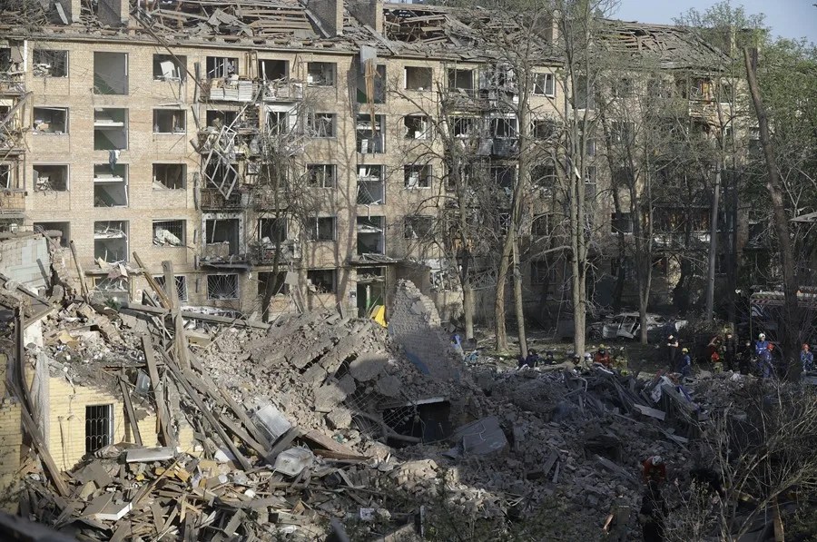 Rescatistas ucranianos trabajan en el lugar del impacto de un cohete en un edificio residencial en Kiev