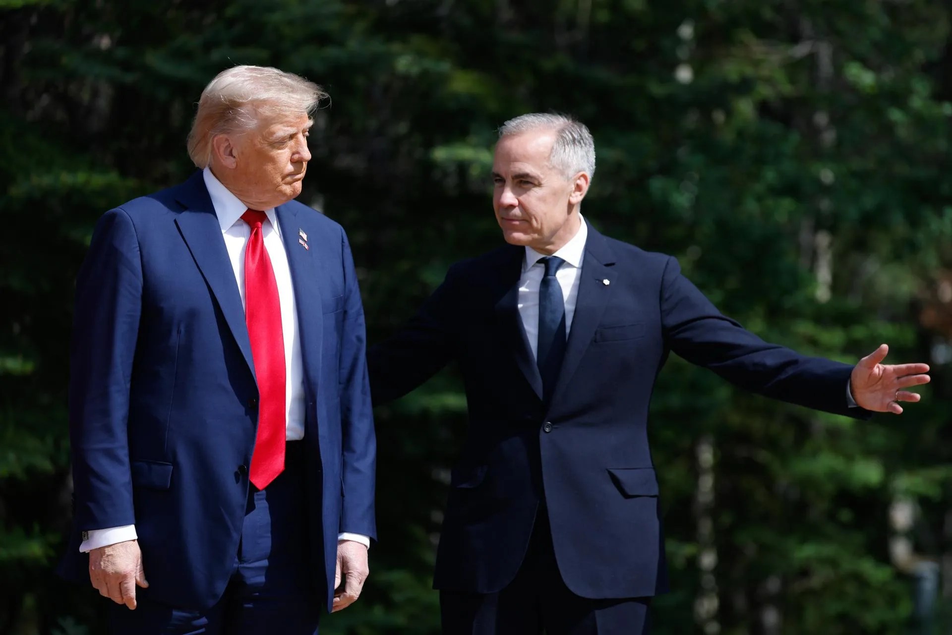 US President Donald Trump (L) and Canadian Prime Minister Mark Carney take part in an arrival ceremony during the Group of Seven (G7) Summit at the Pomeroy Kananaskis Mountain Lodge, in Kananaskis, Alberta, Canada, Jun. 16, 2025. EFE/EPA/LUDOVIC MARIN / POOL