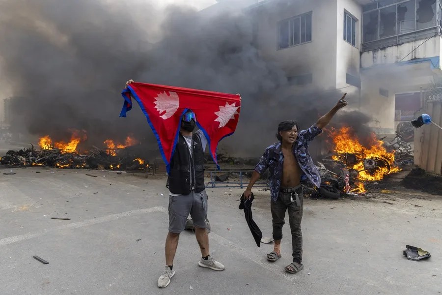 Manifestantes frente a la oficina del Partido Comunista de Nepal - Marxista-Leninista Unificado (CPN-UML) que fue incendiada en Katmandú, Nepal