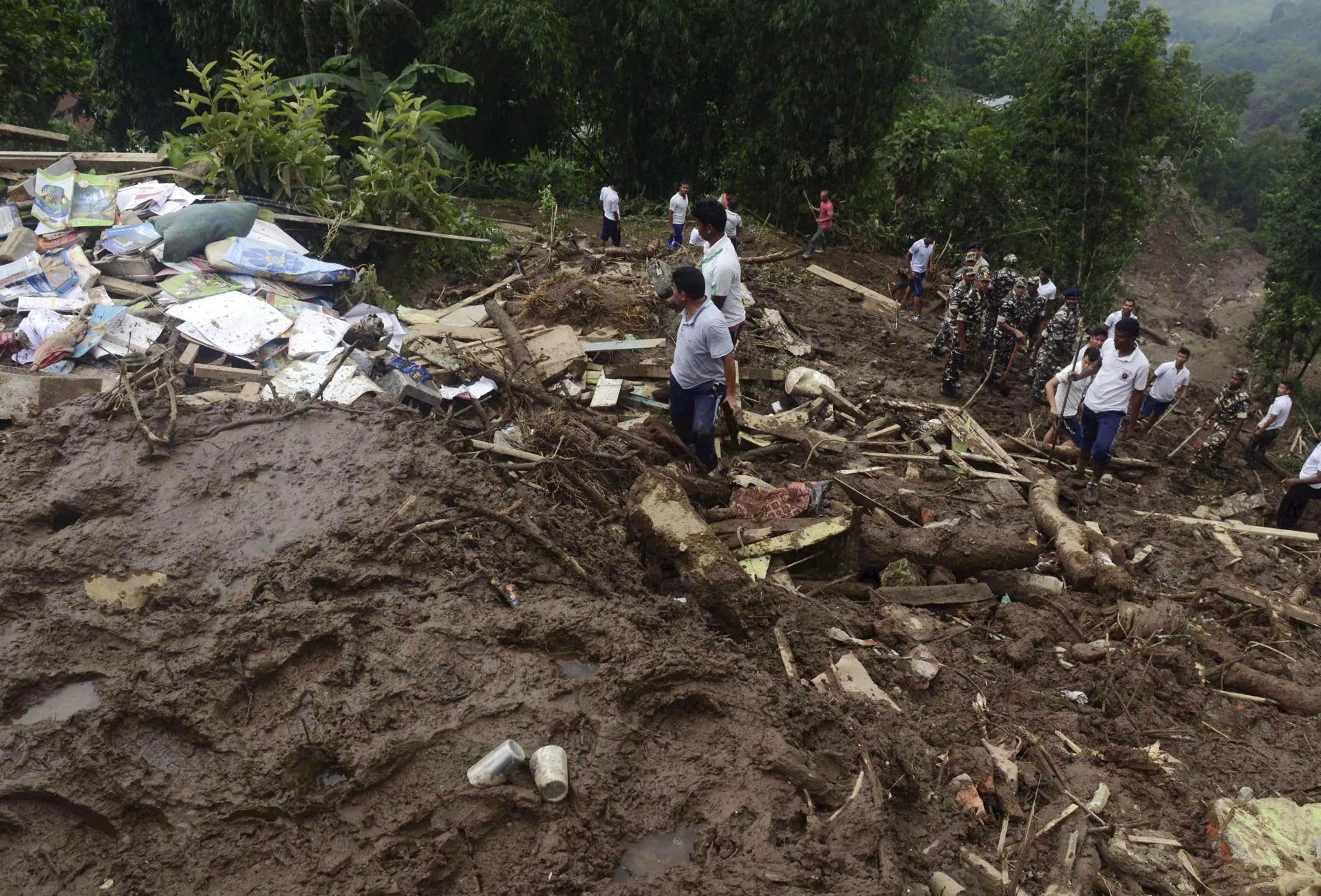 (FILE) People inspecting damages from a landslide caused by heavy rains in Mirik, near Darjeeling, India. EFE/STR