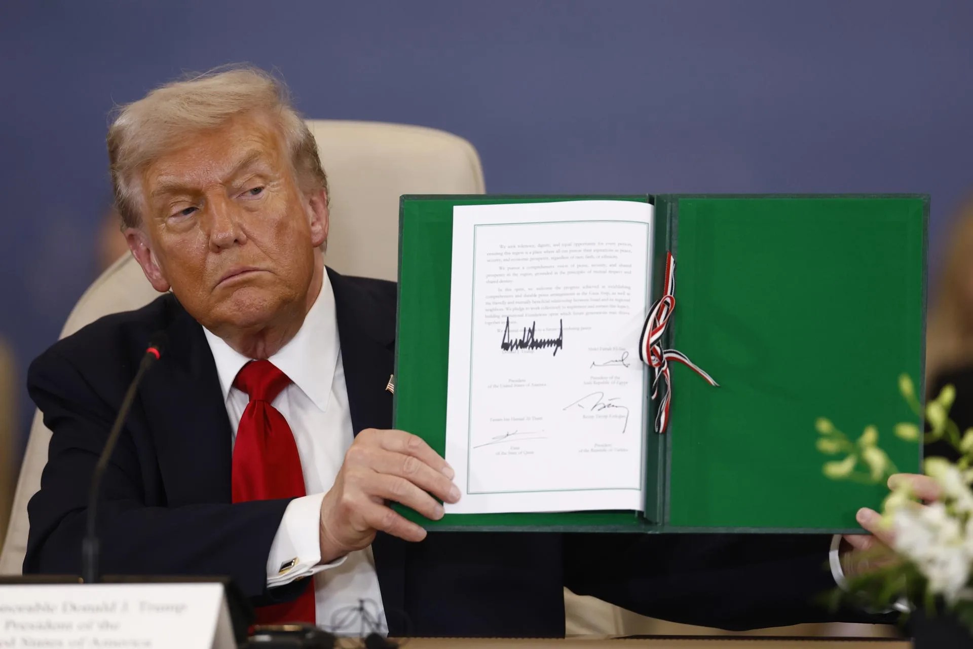US President Donald Trump shows a signed document at the Gaza Peace Summit in Sharm El-Sheikh, Egypt, Oct. 13, 2025. EFE/EPA/YOAN VALAT / POOL