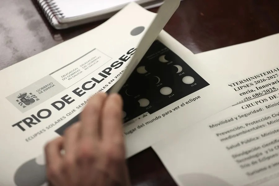 Un asistente a la reunión de coordinación para el eclipse solar del próximo 12 de agosto consulta la documentación.