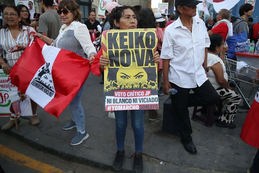 Personas sostienen carteles con la imagen de la candidata presidencial derechista Keiko Fujimori este sábado, durante una manifestación en su contra en Lima (Perú). EFE/ Paolo Aguilar