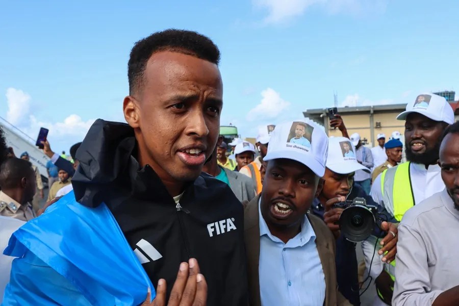 El árbitro de la FIFA, Omar Abdulkadir Artan (C), es recibido por sus seguidores a su llegada al aeropuerto de Mogadiscio