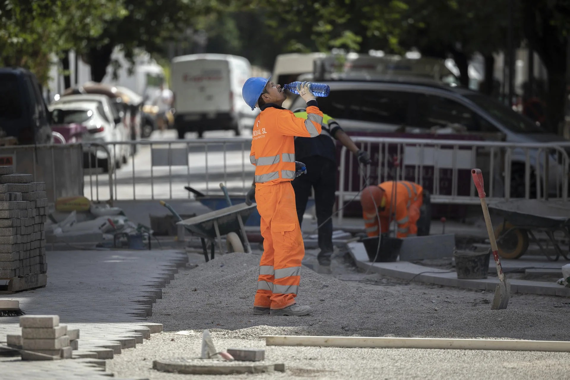 Un trabajador de la construcción bebe agua para combatir el calor en una calle del centro de Valencia. EFE/Biel Aliño