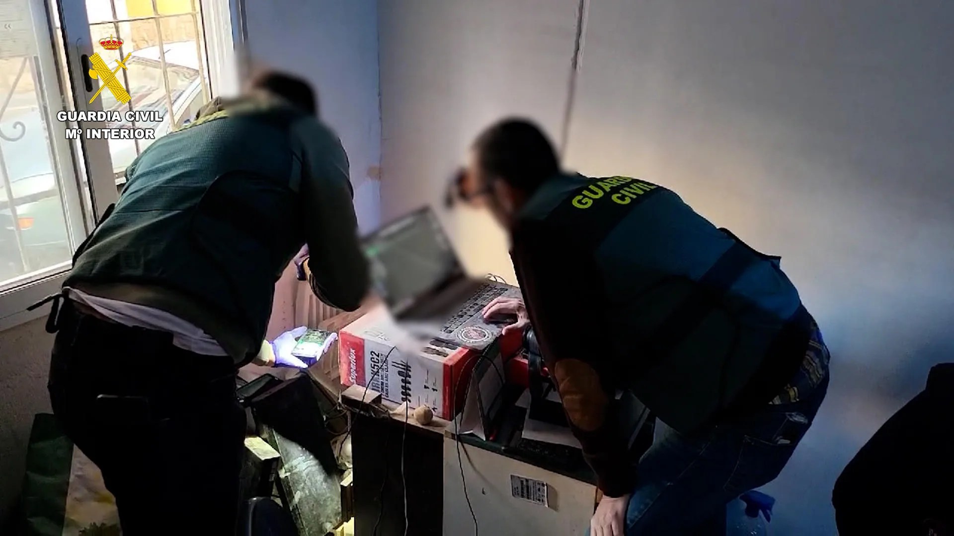 Agentes de la Guardia Civil analizan uno de los dispositivos incautado al ciberpederasta detenido en Alicante que engañó a más de 20 víctimas durante una década. EFE/Guardia Civil
