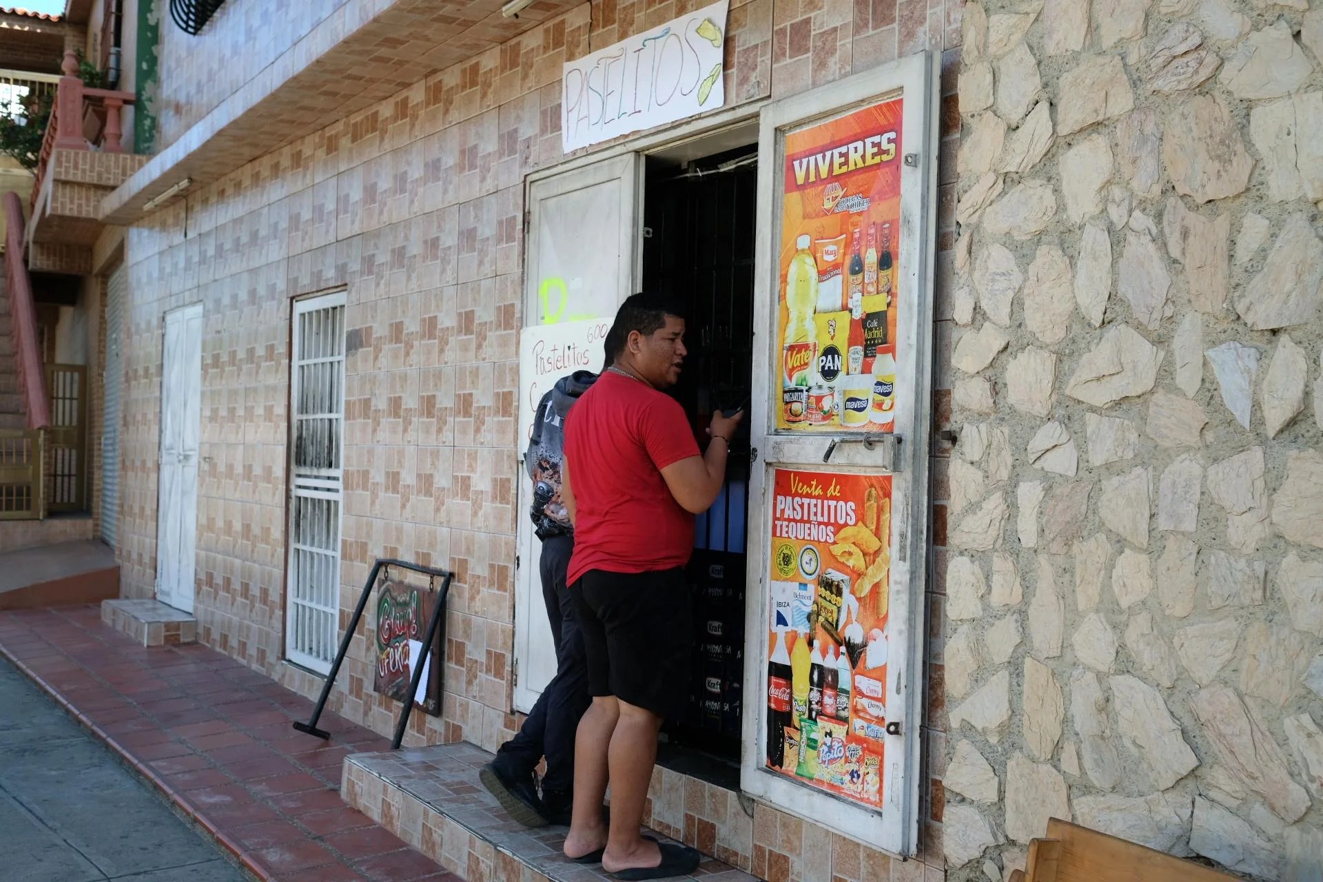 People buy groceries from a shop in Macuto, north of Caracas, Venezuela, 07 July 2026 (issued 08 July 2026). EFE-EPA/XAUME OLLEROS