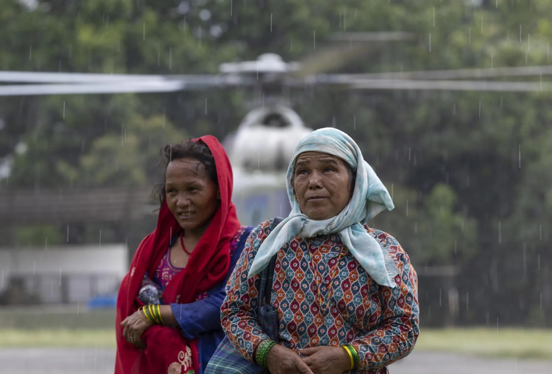People react after being rescued by a Nepal Army helicopter during a rescue operation following flash floods, in Hatiguada village, Nuwakot district, Nepal. Aug. 28, 2026. EFE/EPA/NARENDRA SHRESTHA