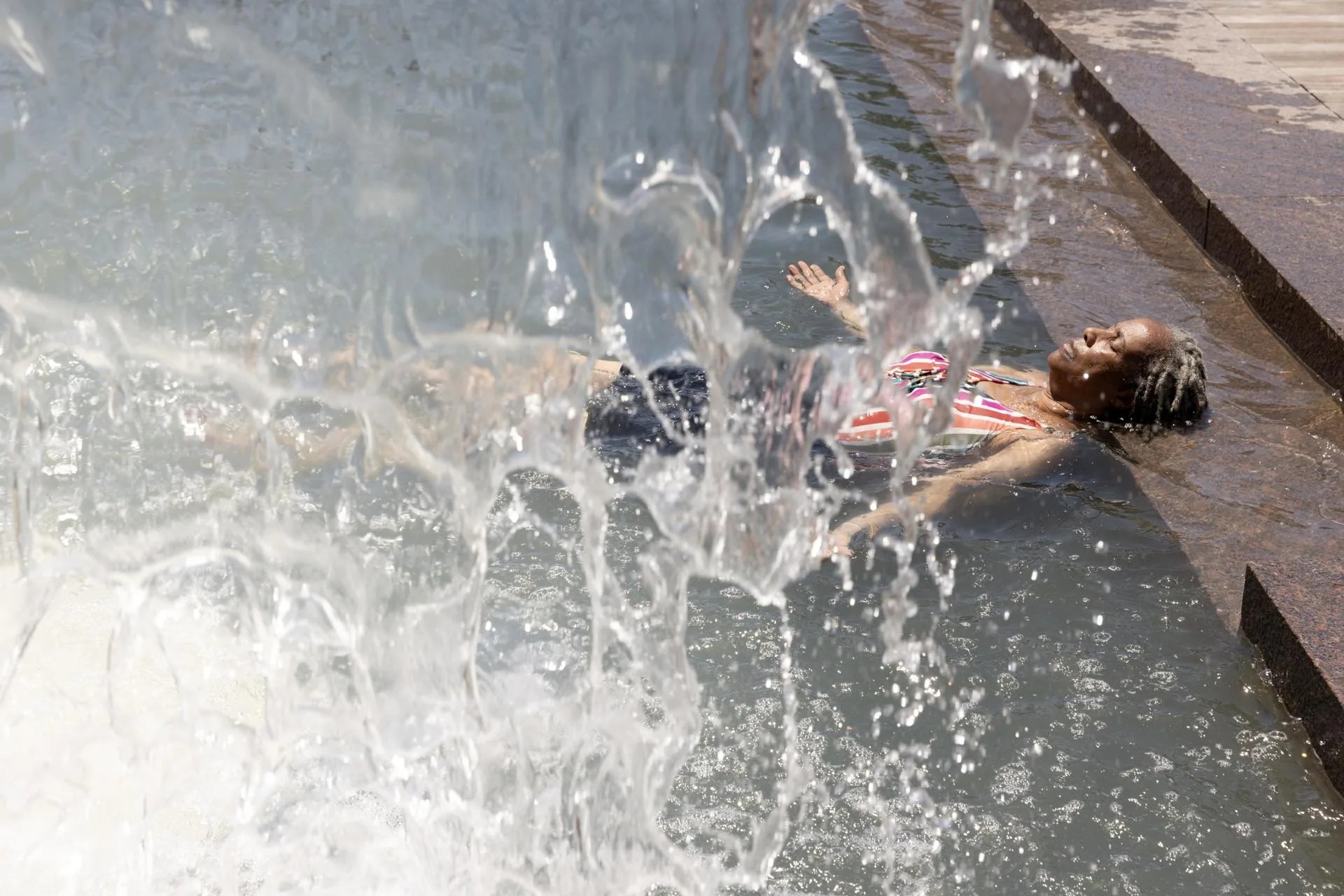 (FILE) A person cools off from the heat in a waterfall at a park as the temperature approaches 94 degrees Fahrenheit (34.44 Celsius) during a heat advisory in Washington, DC, USA, 21 June 2024. EFE/EPA/MICHAEL REYNOLDS