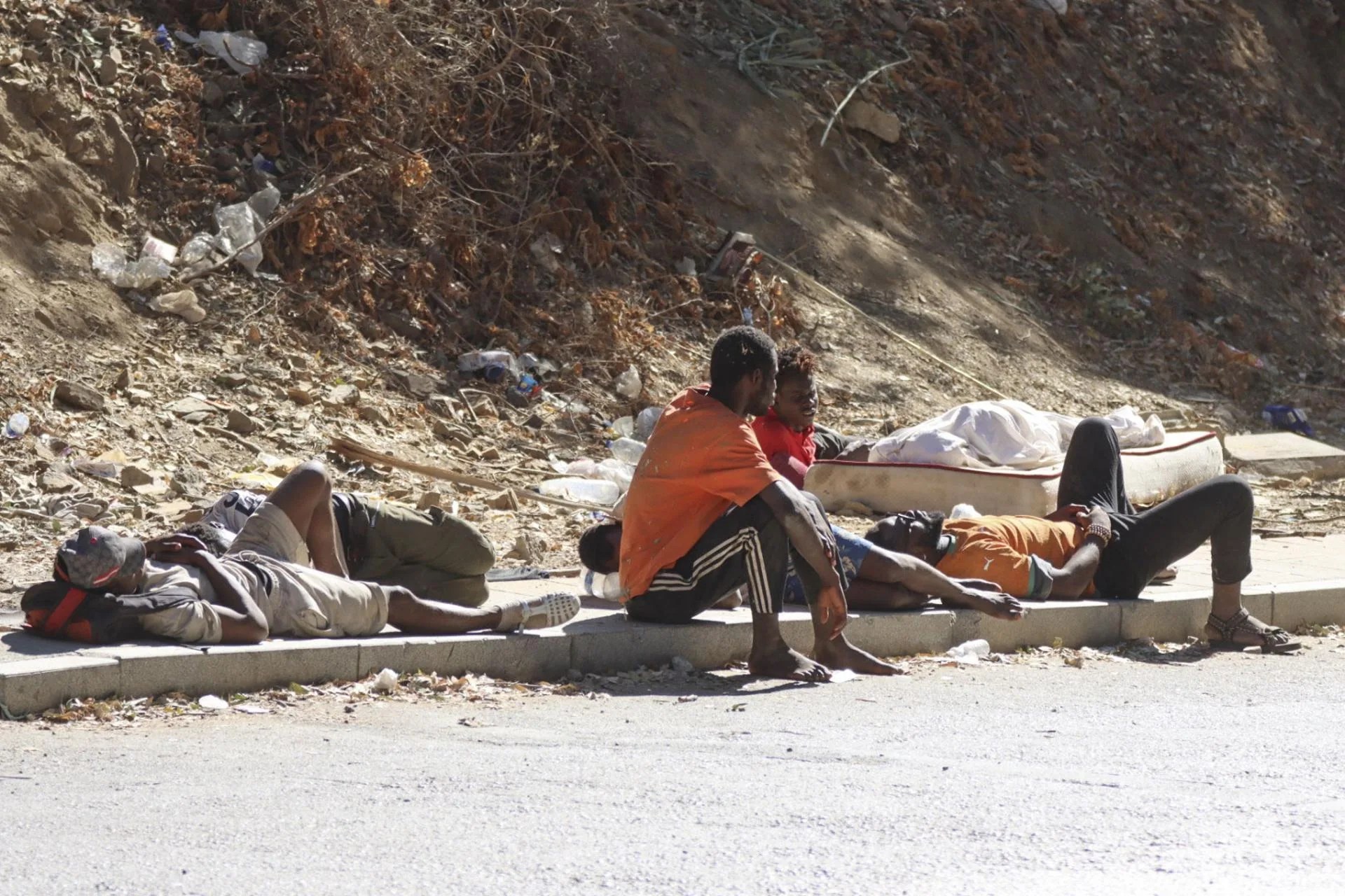 Young migrants who arrived in Ceuta a few days earlier sit near the Temporary Immigrant Accommodation Centre (CETI) in Ceuta, Spain, 04 August 2026. EFE-EPA/REDUAN