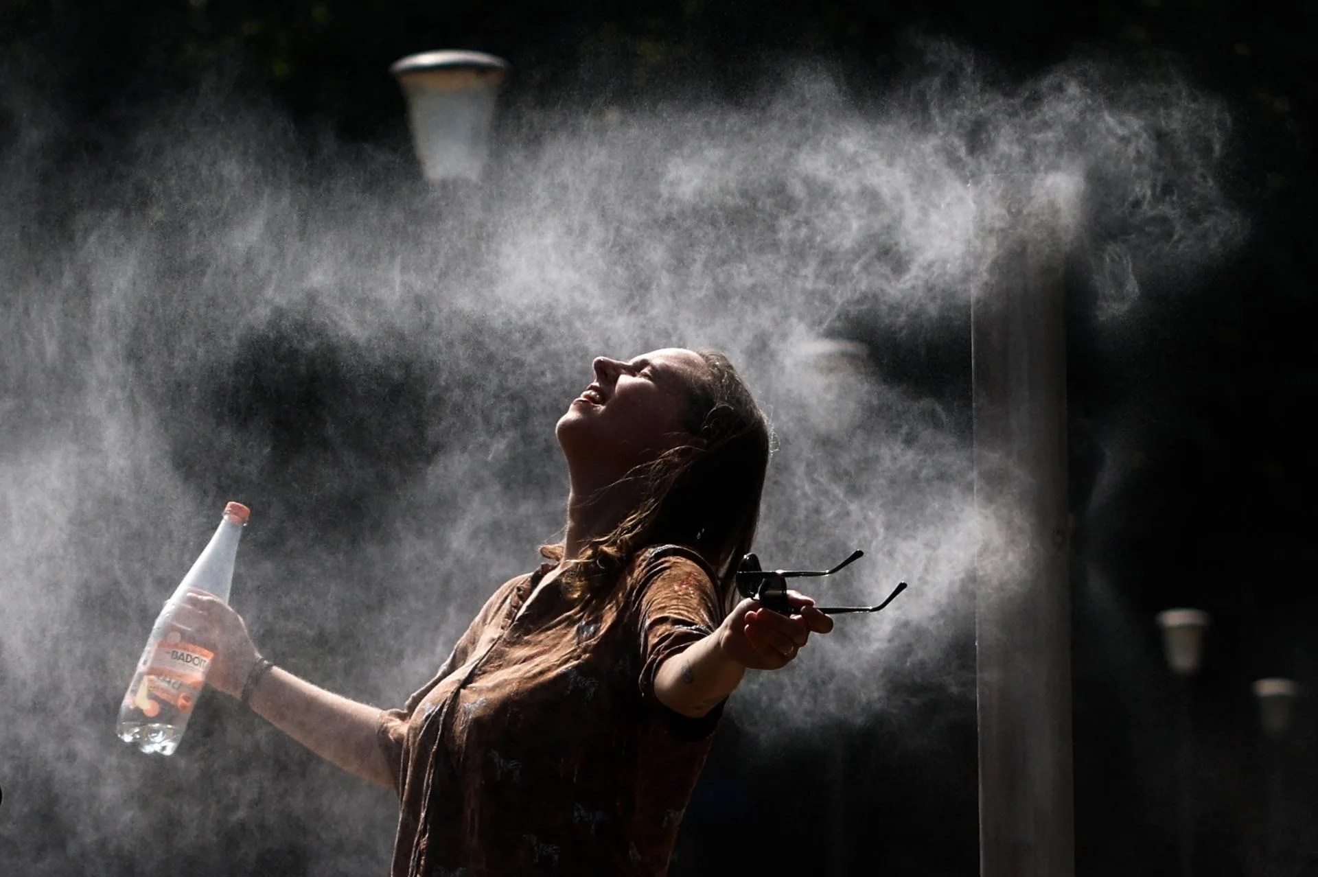 A woman cools off in Bercy Park in Paris. Temperatures rose to 40 degrees on Friday in some French cities during the latest peak so far of a long third heat wave this summer, which is set to subside starting this weekend, though it is not yet clear when it will end, and with no rain in sight to alleviate the historic drought. Aug. 14, 2026. EFE/MOHAMMED BADRA