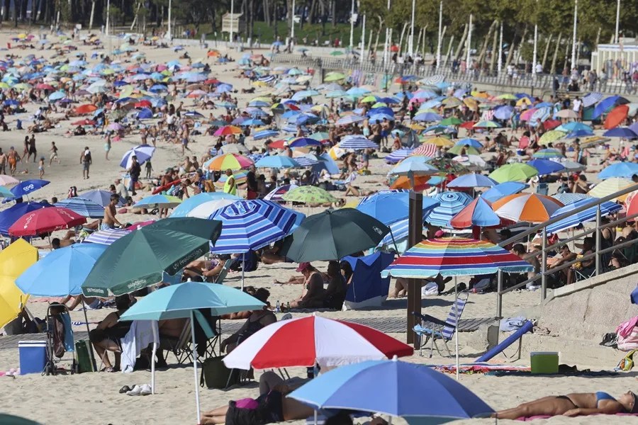 Decenas de bañistas disfrutan del domingo en la playa de Samil de Vigo.