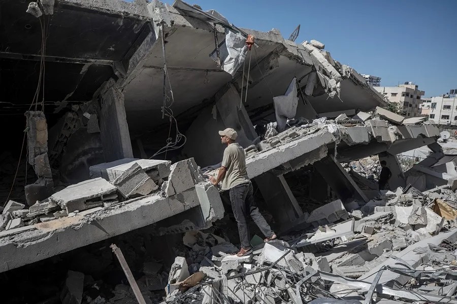 Un hombre palestino busca a personas desaparecidas entre los escombros de un edificio derrumbado en la ciudad de Gaza, en la Franja de Gaza.