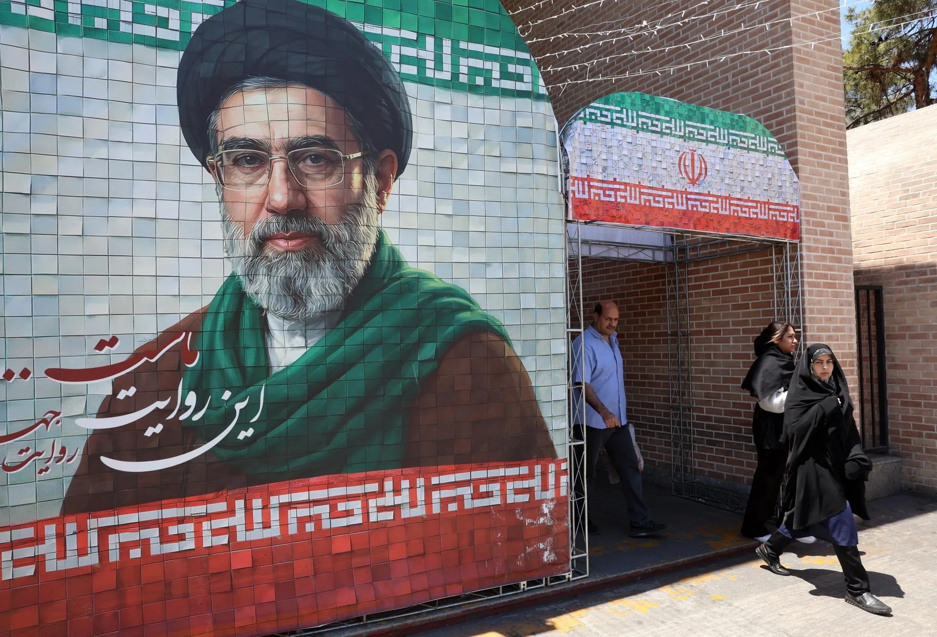[FILE] Iranians walk past an image of Iranian Supreme Leader Ayatollah Mojtaba Khamenei on a street in Tehran, Iran, on Monday, May 18, 2026. EFE-EPA/ABEDIN TAHERKENAREH