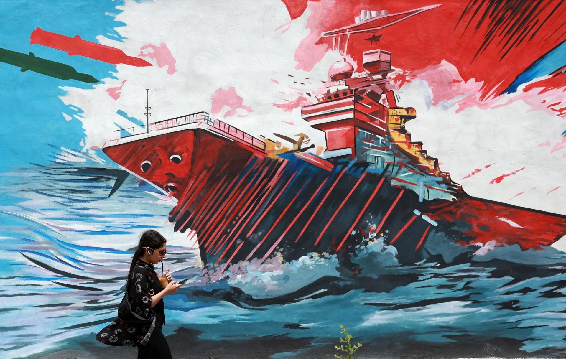 (FILE) An Iranian walks next to an anti-US mural in a street in Tehran, Iran. EFE/EPA/ABEDIN TAHERKENAREH
