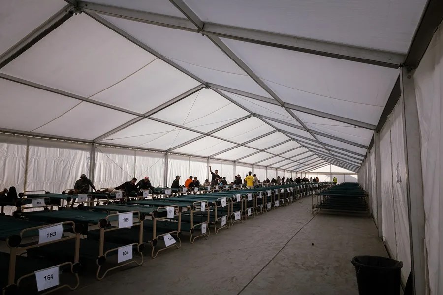 Un grupo de migrantes a su llegada este viernes al campamento temporal habilitado en el puerto de Ceuta.