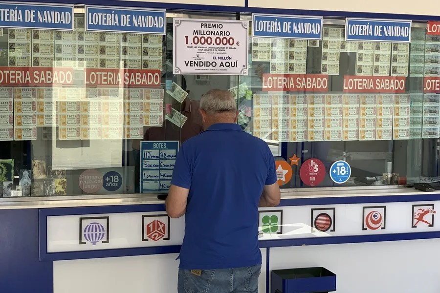 Un hombre adquiere un boleto de Lotería