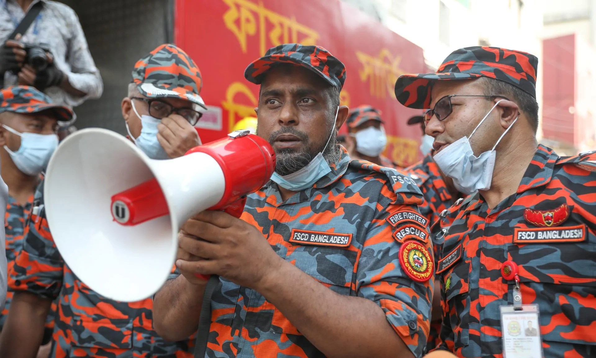(FILE) A firefighter uses a megaphone to alert people after a fire swept through a chemical warehouse and a garment factory in Mirpur's Shialbari area, Dhaka, Bangladesh, 15 October 2025. EFE/EPA/MONIRUL ALAM