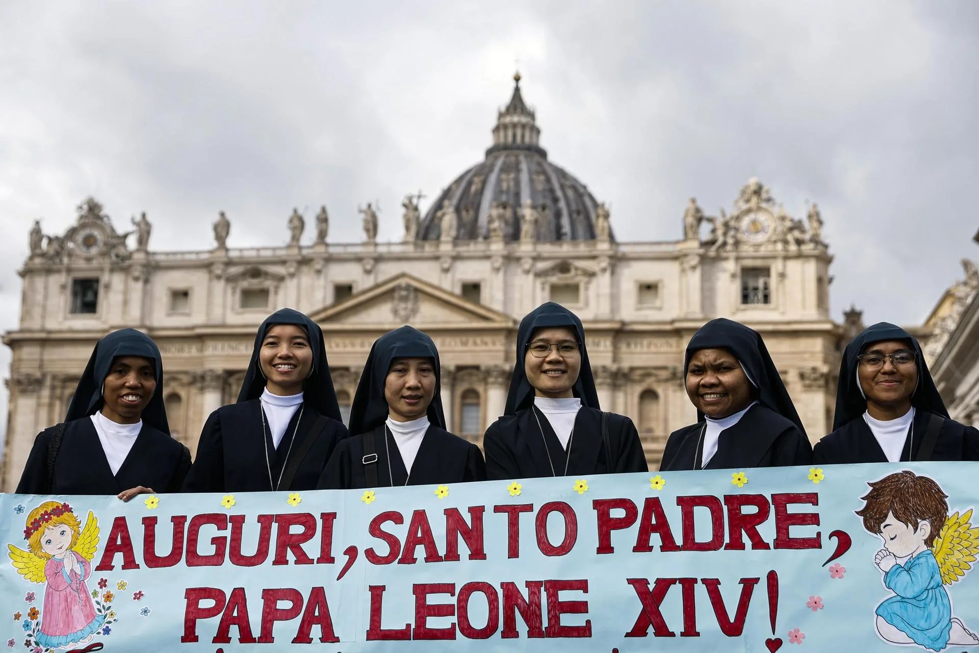 Nuns pose with a banner offering good wishes to Pope Leo XIV as they gather to attend the Angelus prayer led by the pontiff from the window of his office overlooking Saint Peter's Square in Vatican City, 18 October 2026. EFE-EPA/ANGELO CARCONI
