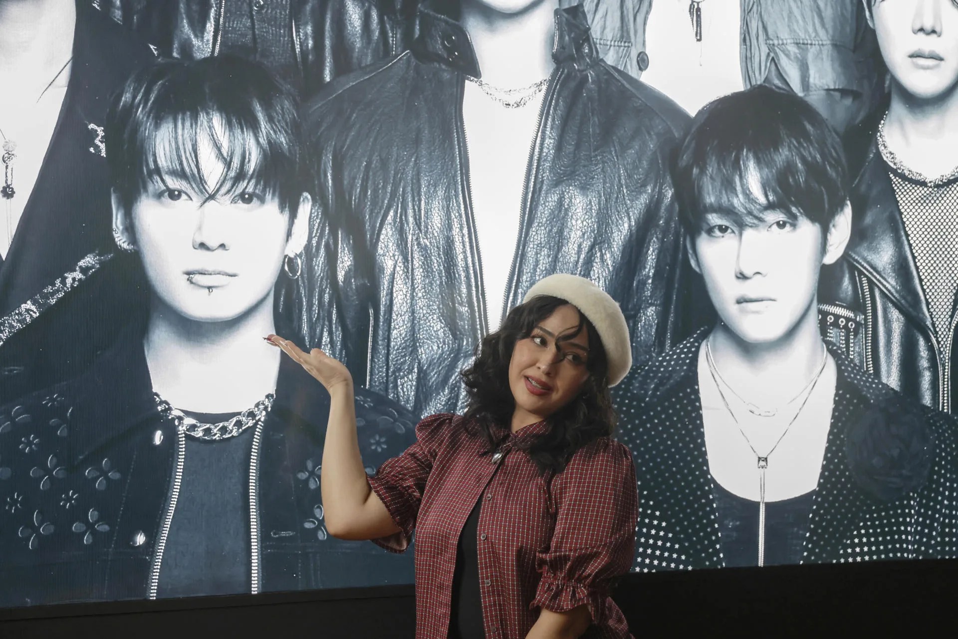 A fan of the South Korean group BTS poses in front of photos of the artists this Wednesday in Bogotá, Colombia. For Colombian fans, the K-pop group BTS is much more than just music: it represents community, travel, projects, and even a unique way of celebrating the arrival of the South Korean group, which kicks off its highly anticipated Latin American tour in Bogotá this Friday. EFE/ Carlos Ortega