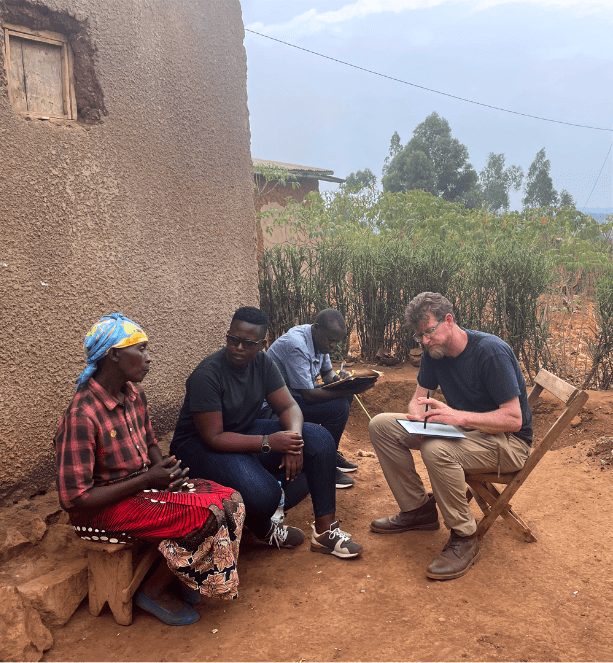 group of people gathered around a man filling out an organizational development tool