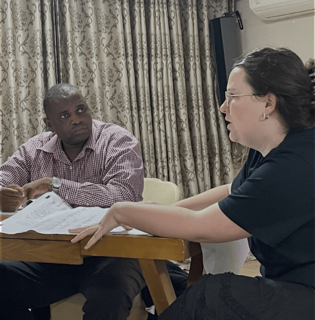 Man and woman talking at a table about organizational development