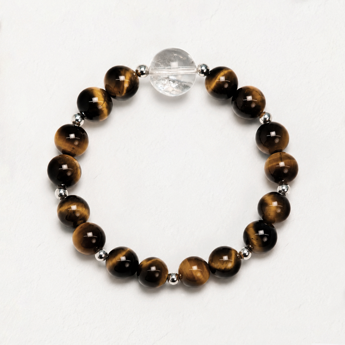 Sunlit Resolve natural crystal bracelet with Golden Tiger’s Eye and Clear Quartz on a white background.