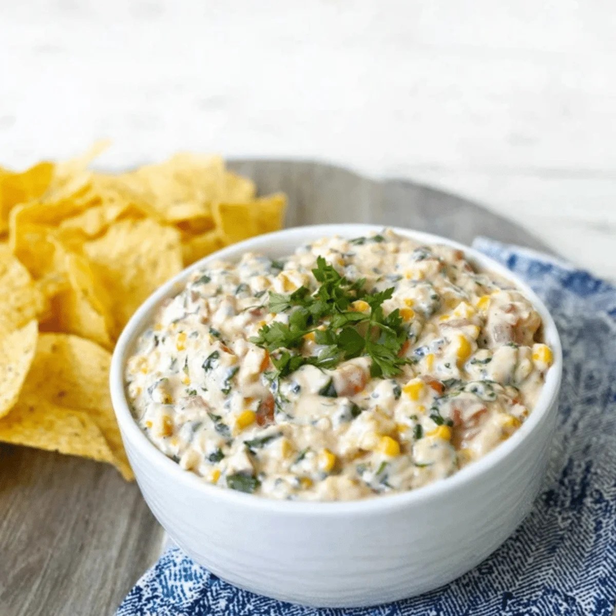 Vibrant healthy poolside dip in a serving bowl with fresh vegetable dippers.
