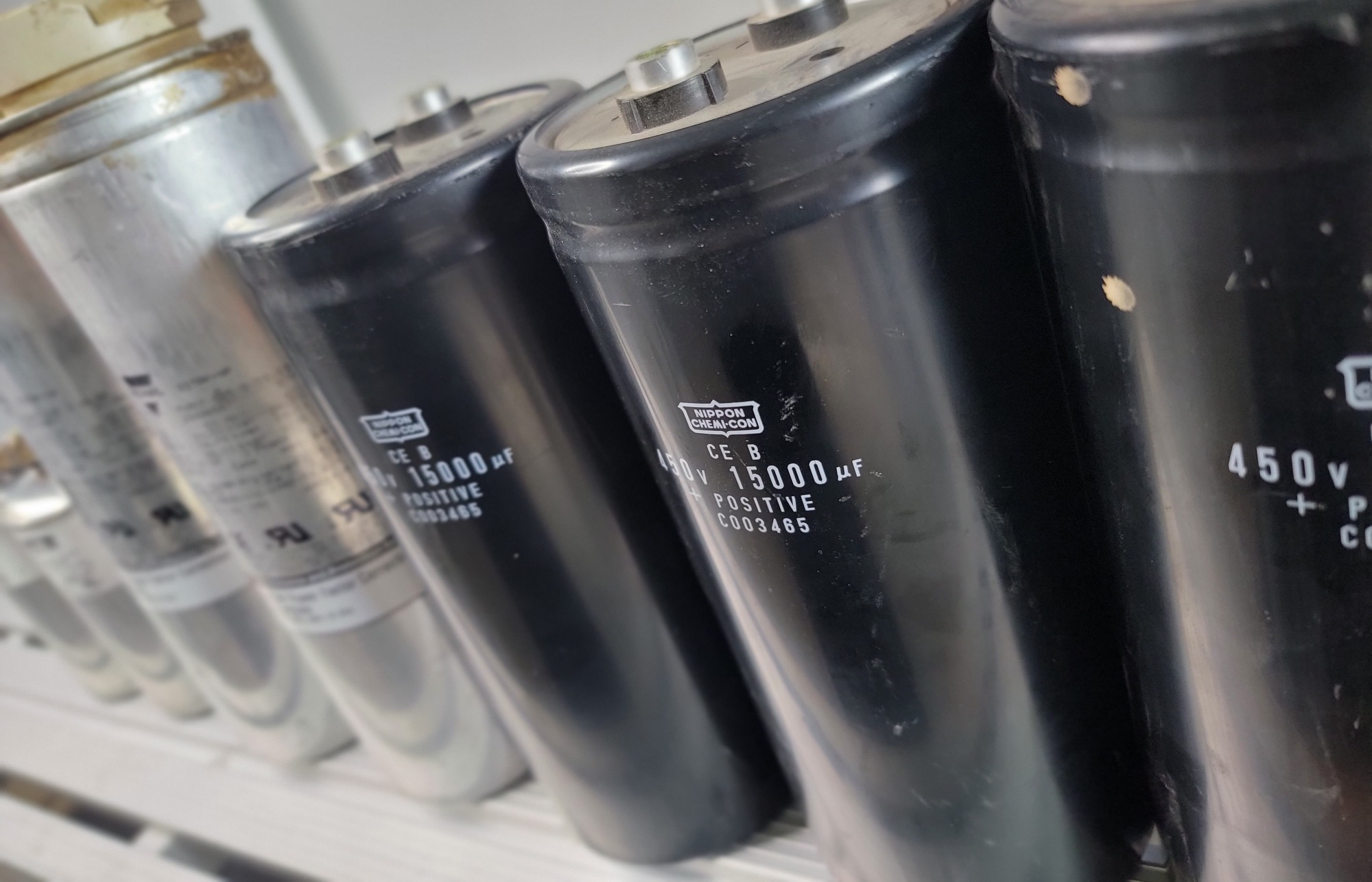 Black and silver capacitors arranged in a row