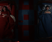 Two individuals in separate beds, a girl in red with a stuffed animal on the left and a boy in blue with a stuffed animal on the right, in a colorful room with a geometric floor pattern.