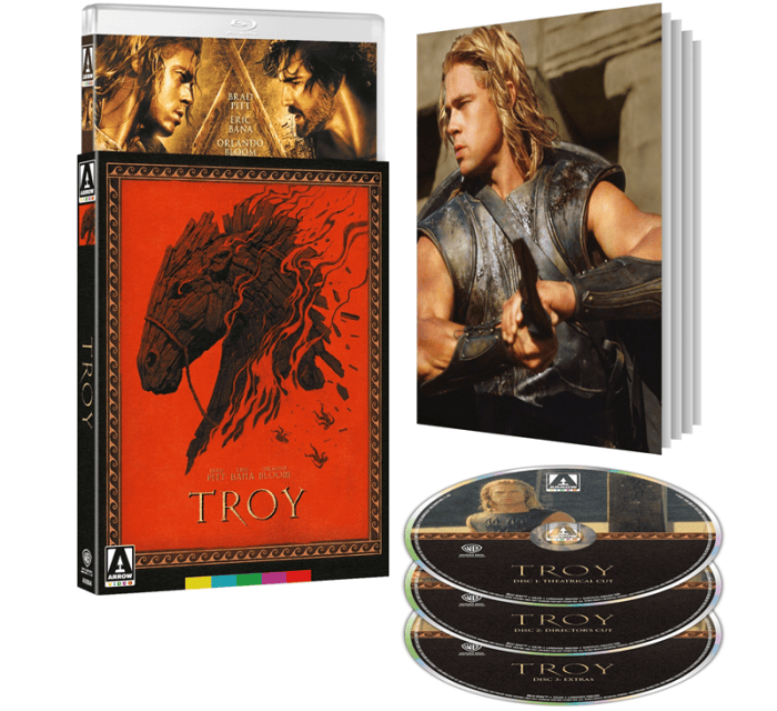 Packshot for the film "TROY" featuring a red DVD case with a horse illustration, two Blu-ray discs, and a booklet with scenes from the film.