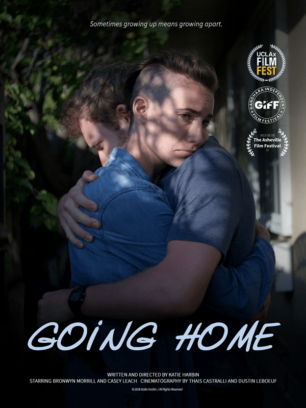 Film poster for GOING HOME showing two people embracing outdoors, with the title in large light-blue script at the bottom.