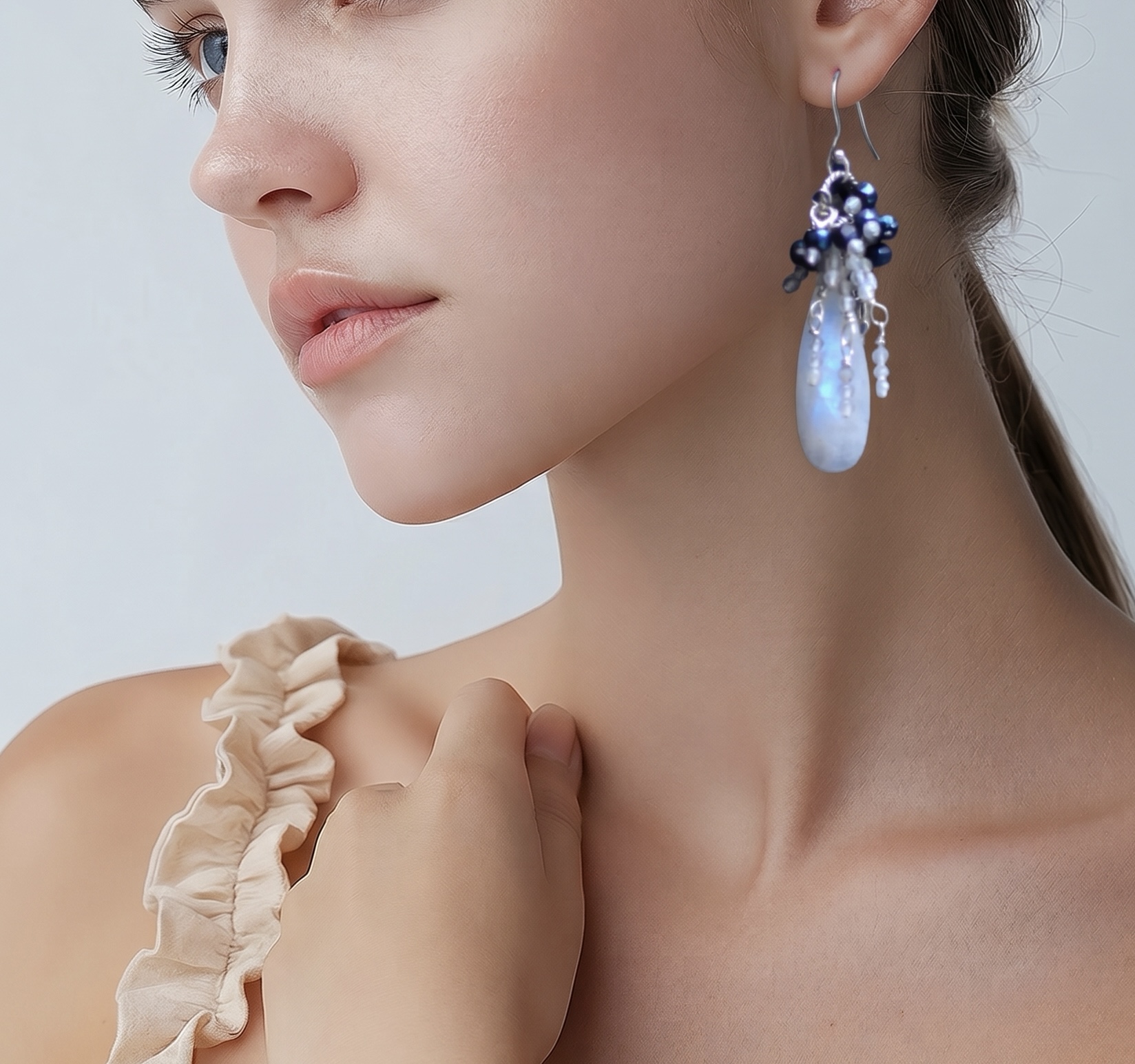 Large moonstone gemstone cluster sterling silver earrings. Shown on a model.