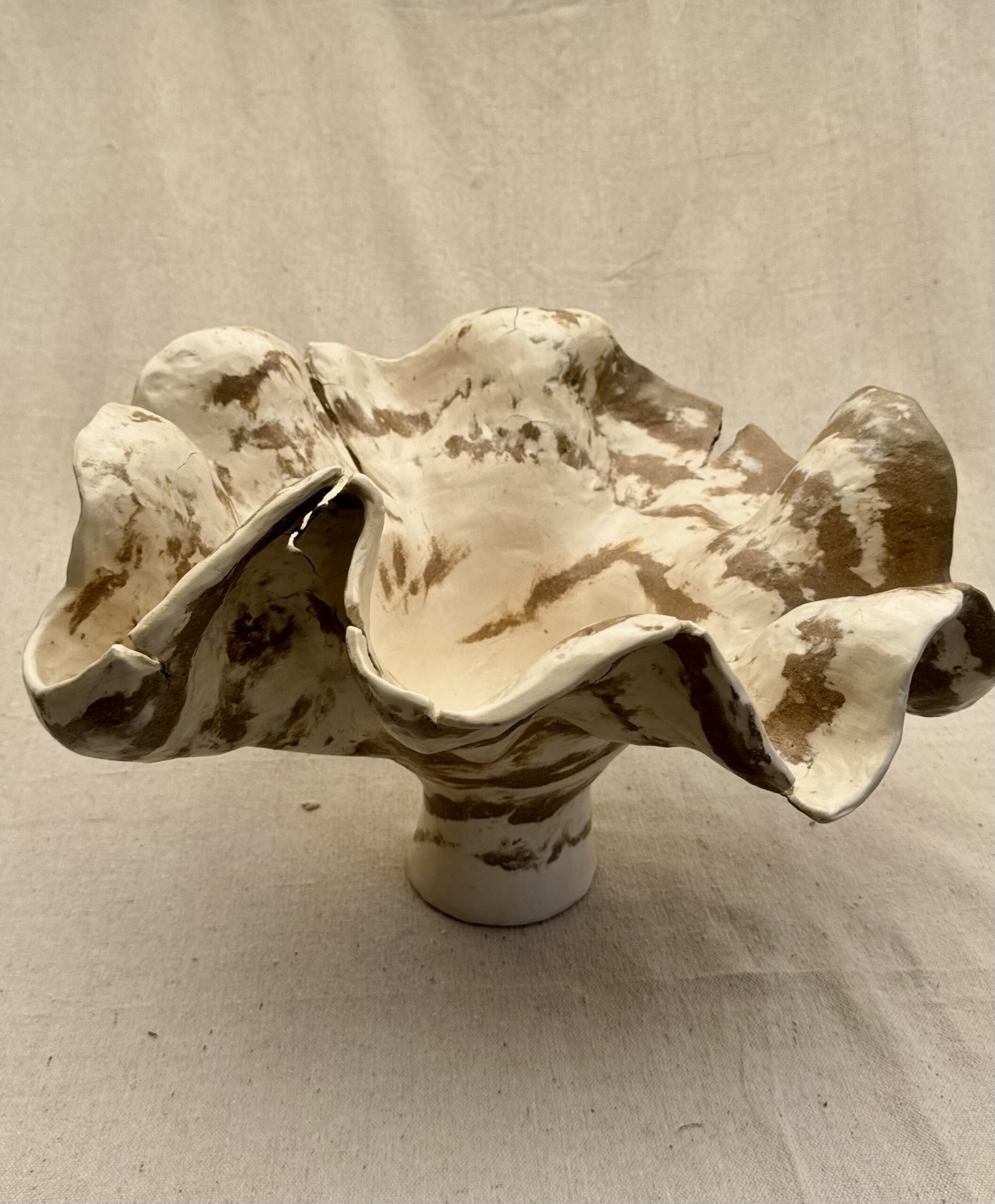 Ceramic Agateware Art Vase This large handcrafted ceramic vase features an organic, sculptural form inspired by mountains. The combination of brown and white color clays coiled in a spontaneous pattern gives a dynamic flow of color patterns and reminds you of a marble stone. Every curve carries the memory of touch - intentionally imperfect and alive. Dimensions: 14” wide X 14" deep X 9" tall.
