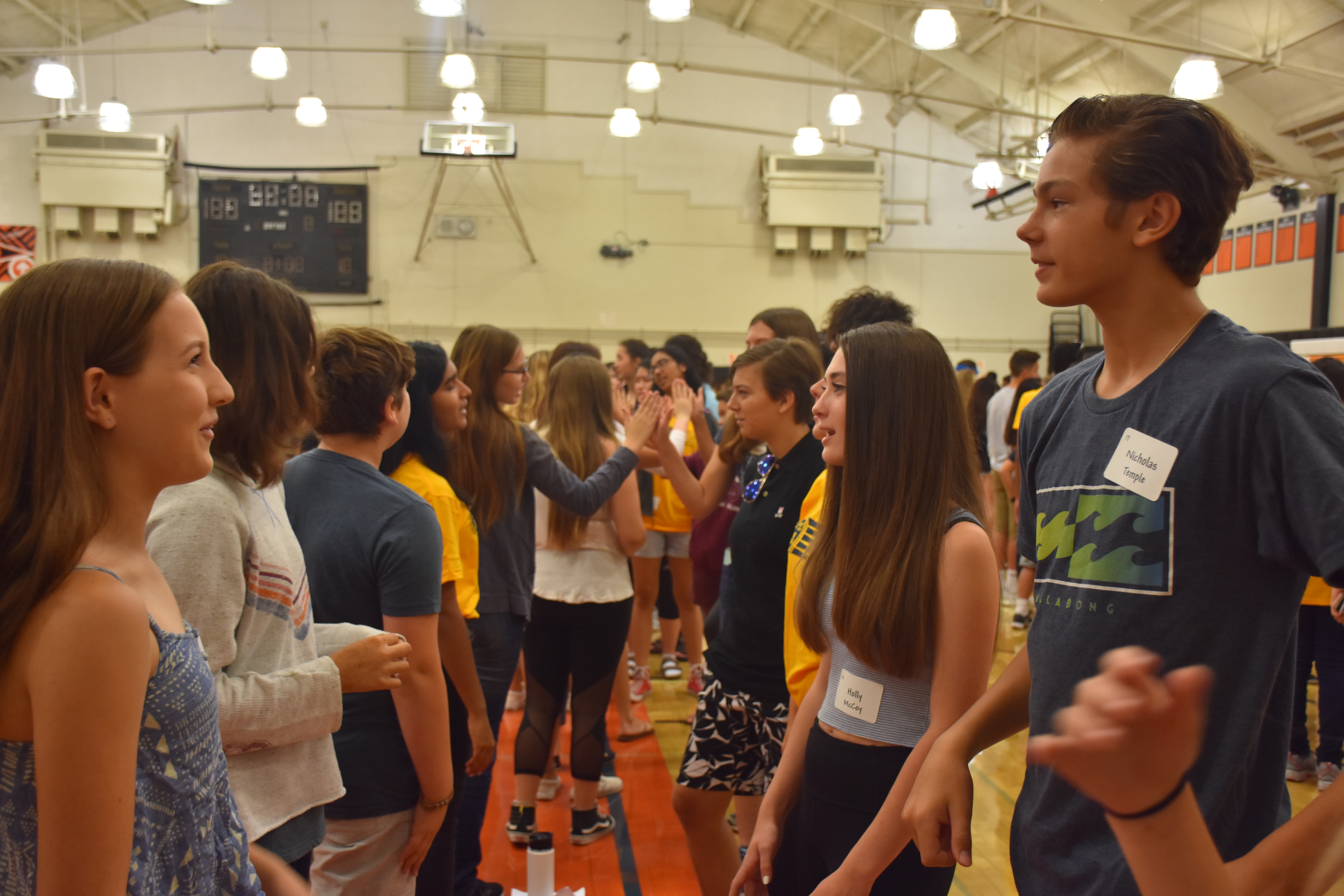 Freshman introduce themselves to each other in their lines as another activity