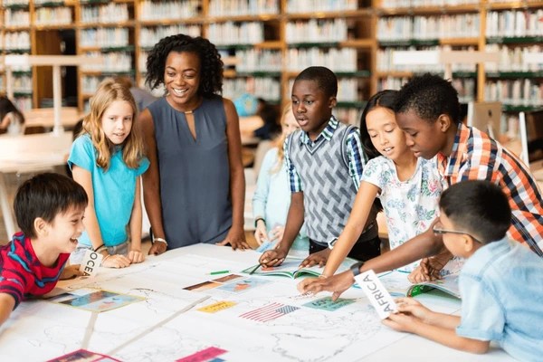 A circle of students sharing ideas and working together on a common project, capturing the essence of collaborative learning.