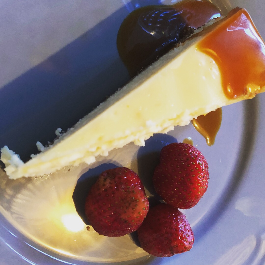 Delicious Polish cheesecake with berries and salted caramel sauce