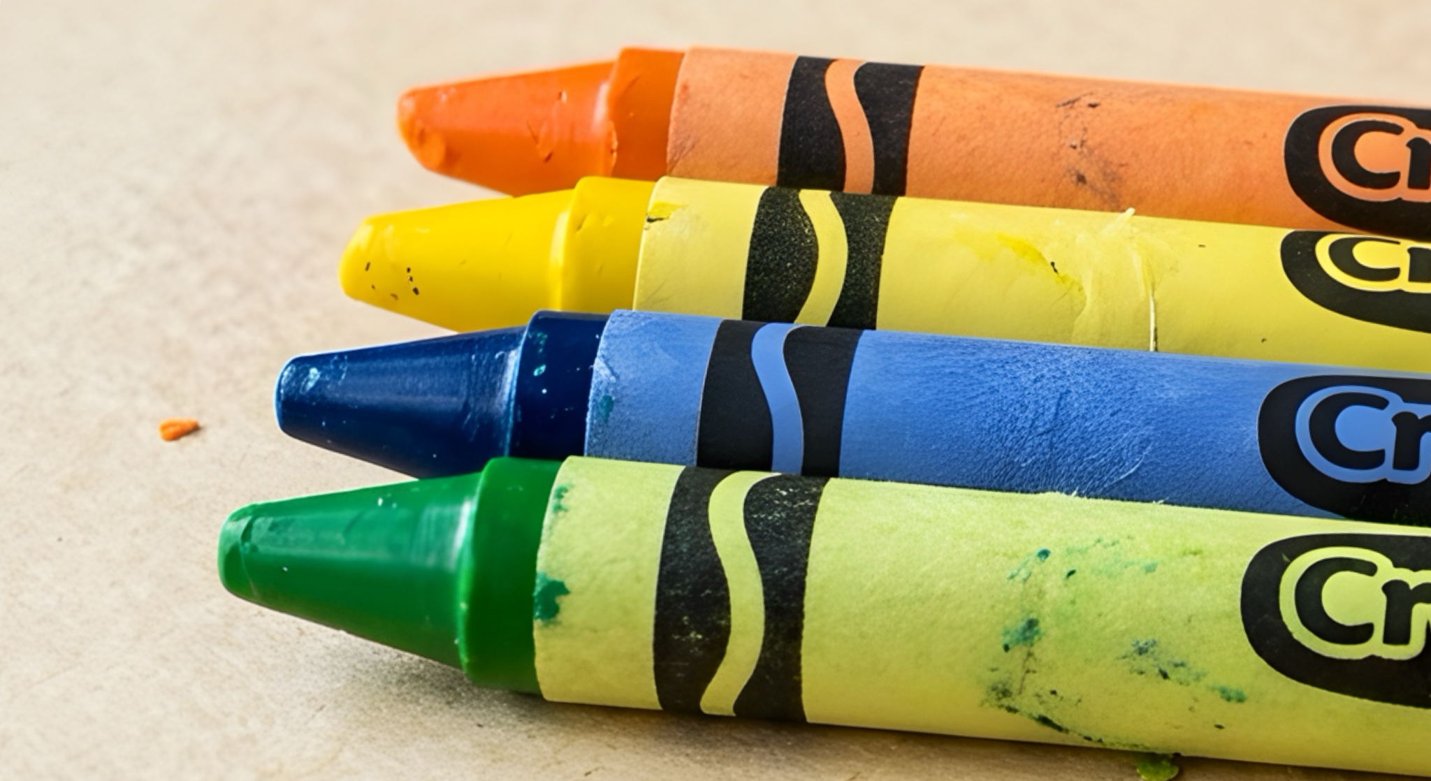 Green, blue, yellow, and orange crayons