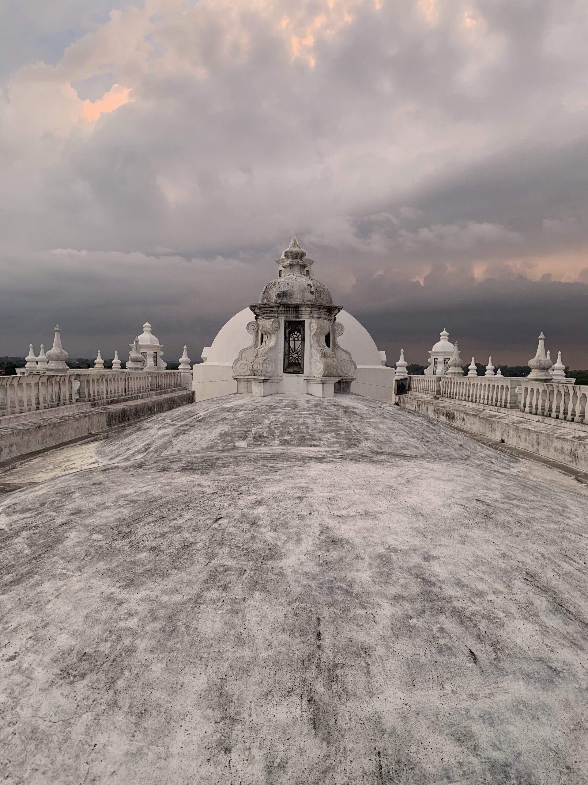 The rooftop of León cathedral at sunset with a storm in the background