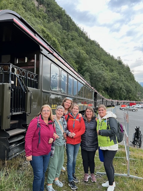 Group of ladies in front of a train