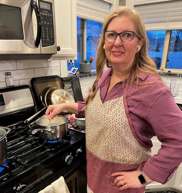 Kim cooking with earbuds in