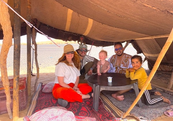 Moha and travellers hosted by locals under a berber tent