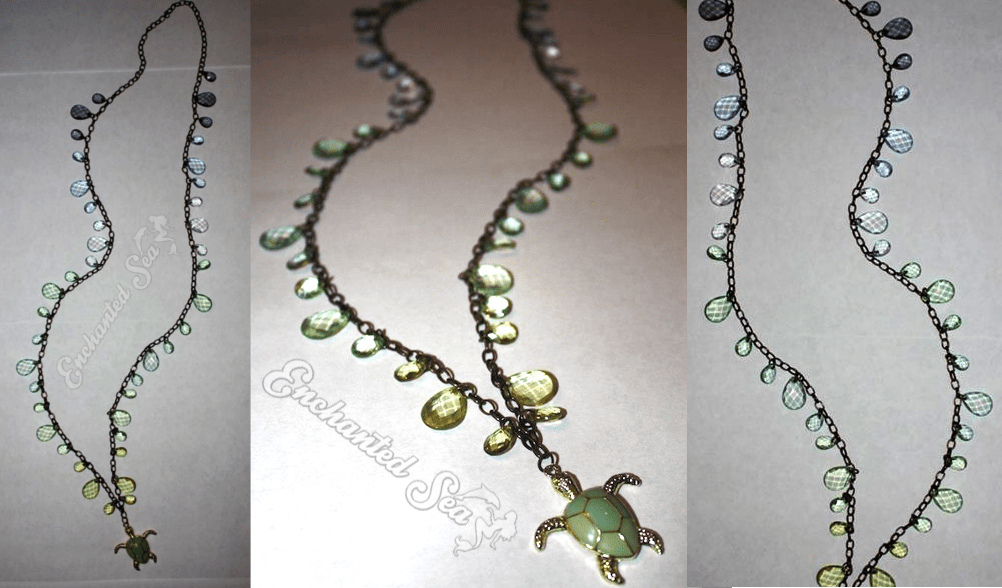 An ornate sea turtle dangles from ombre shades of ocean blues and sea foam green glass crystals.