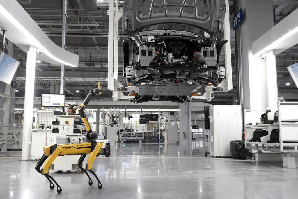 Boston Dynamics Spot robot performing automated quality inspection beneath a vehicle chassis