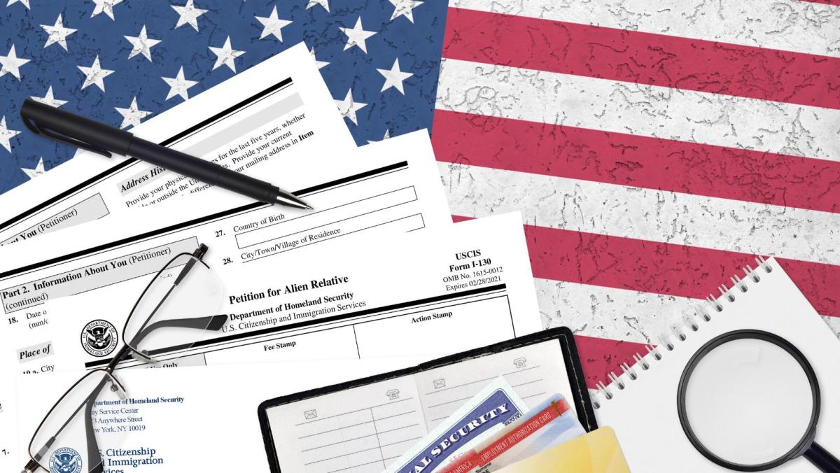 Formatos para solicitar la Green card por petición familiar con la bandera de Estados Unidos para ilustrar noticia sobre las limitantes que existen para solicitar la residencia permanente